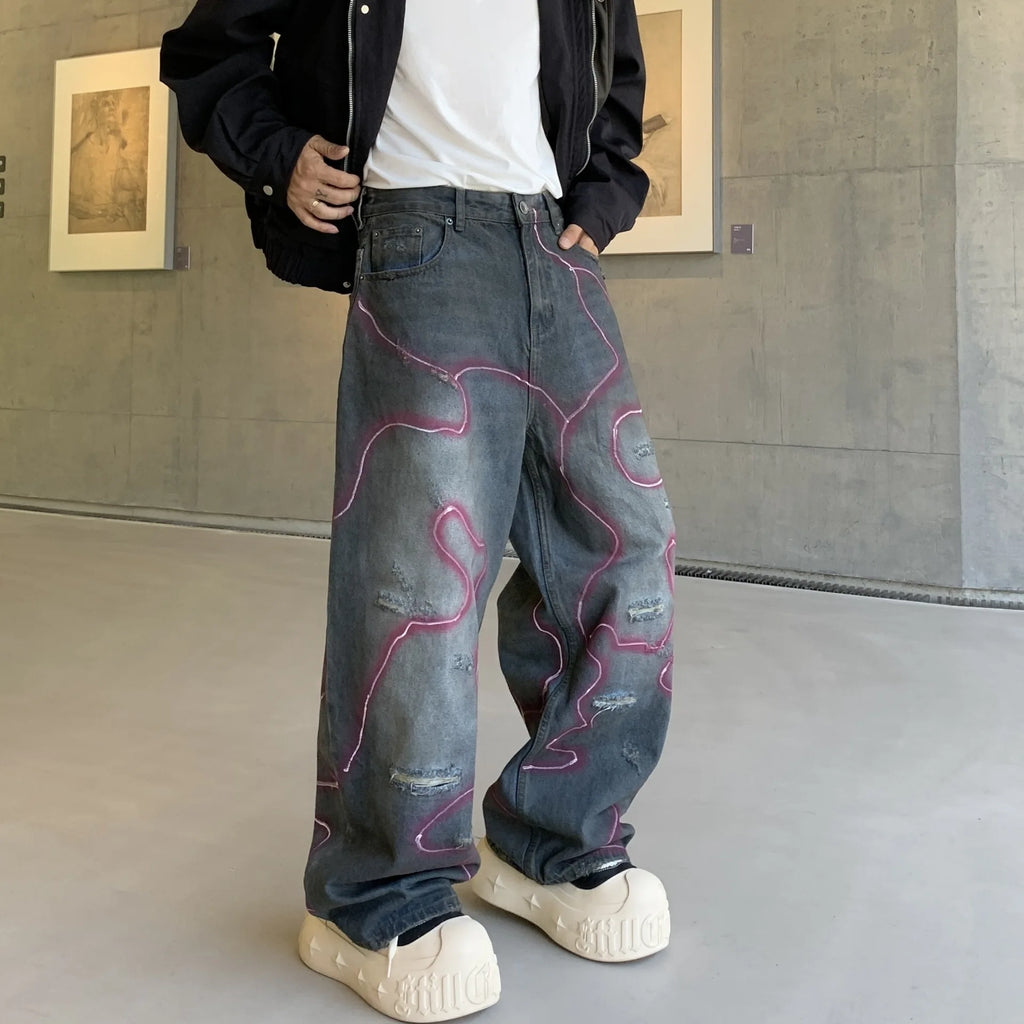 LE JEAN EN DENIM DÉLAVÉ GRAFFITI OUTLAW