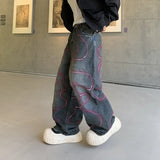 LE JEAN EN DENIM DÉLAVÉ GRAFFITI OUTLAW