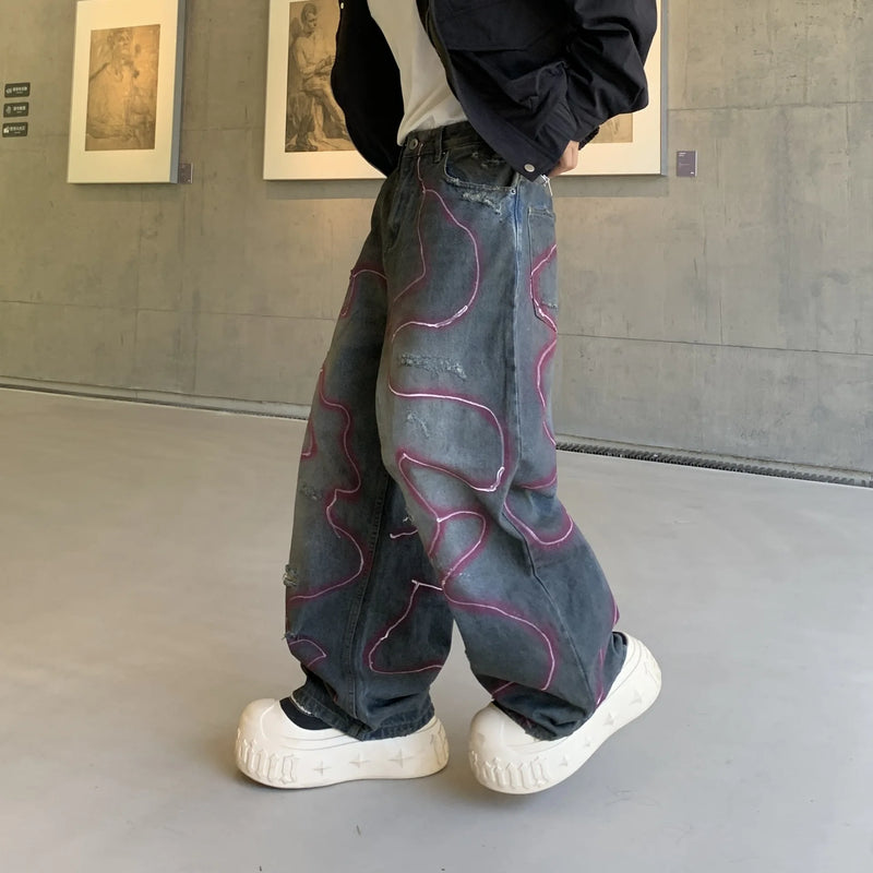 LE JEAN EN DENIM DÉLAVÉ GRAFFITI OUTLAW