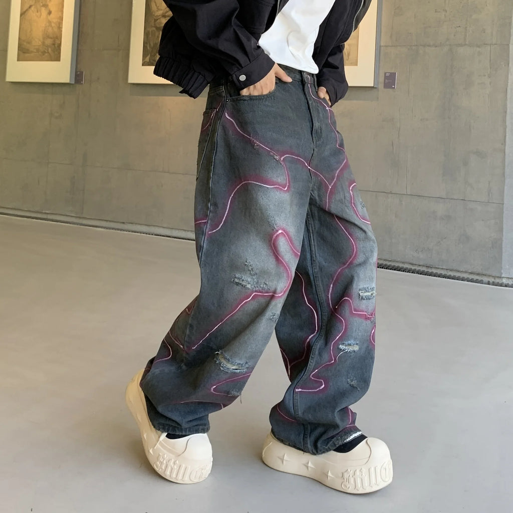 LE JEAN EN DENIM DÉLAVÉ GRAFFITI OUTLAW