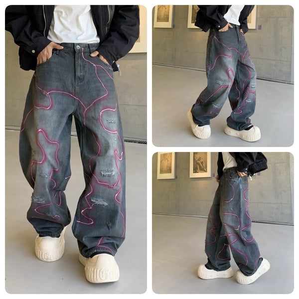 LE JEAN EN DENIM DÉLAVÉ GRAFFITI OUTLAW