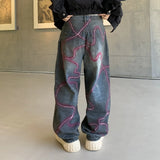 LE JEAN EN DENIM DÉLAVÉ GRAFFITI OUTLAW