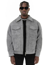 Man wearing a gray suede jacket on a white background